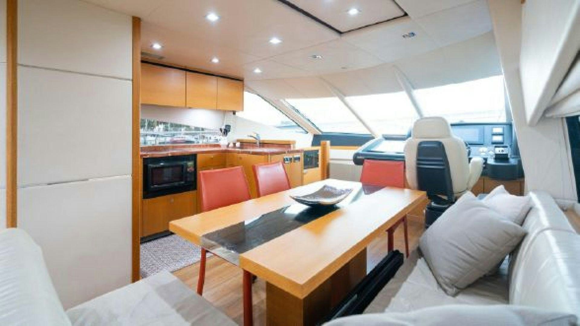a room with a table and chairs aboard MANCUSA Yacht for Sale