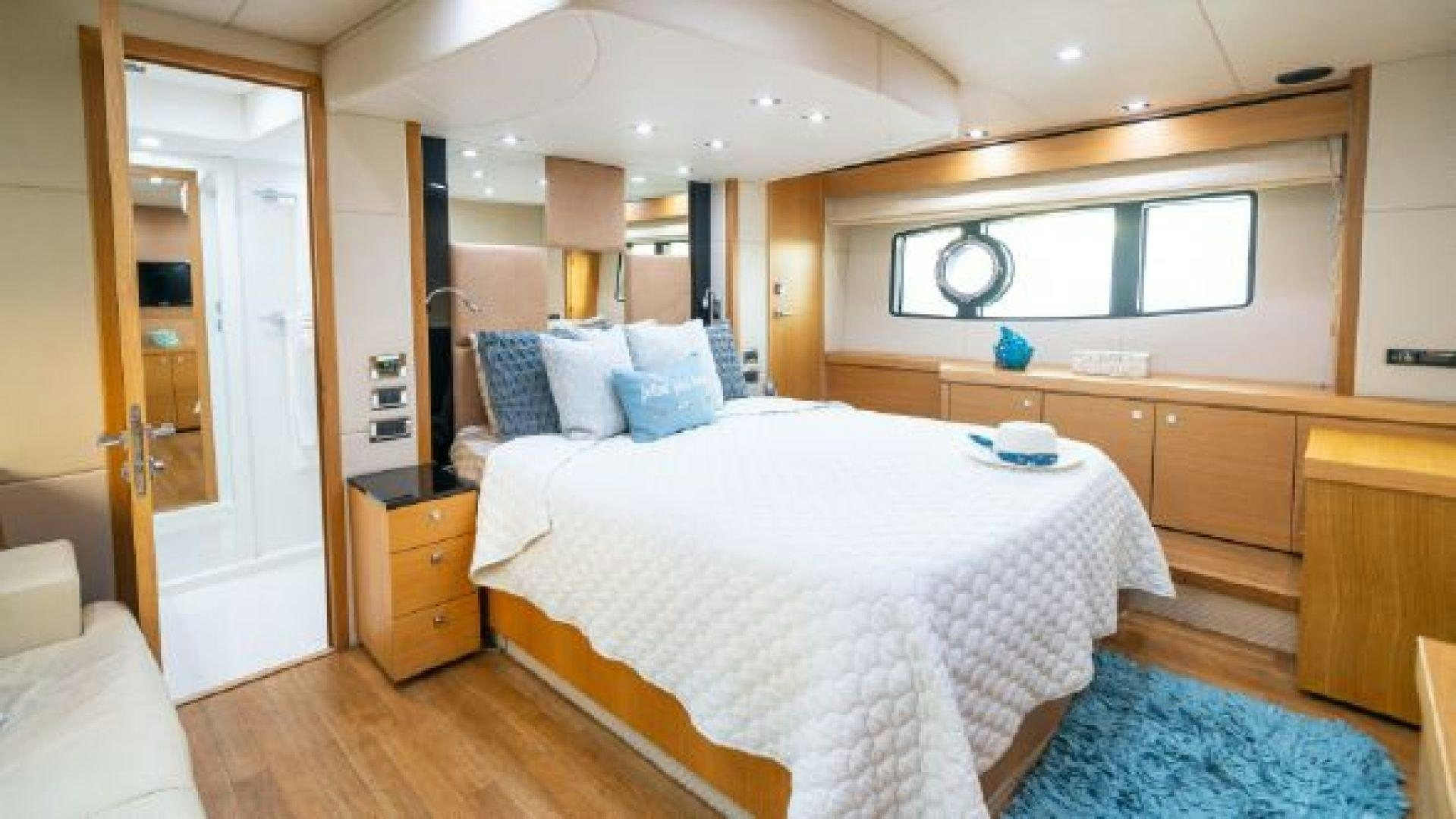 a bedroom with a bed and a desk aboard MANCUSA Yacht for Sale