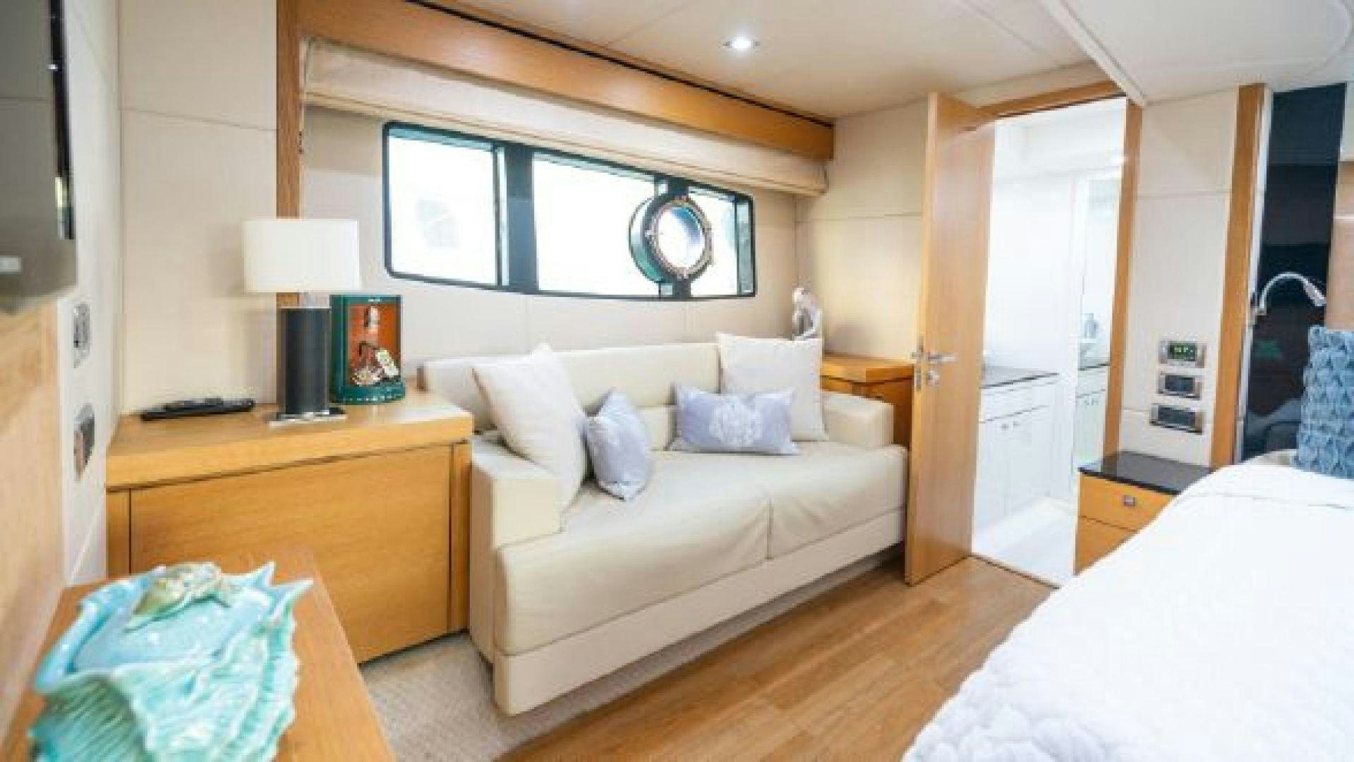 a bedroom with a bed and a desk aboard MANCUSA Yacht for Sale