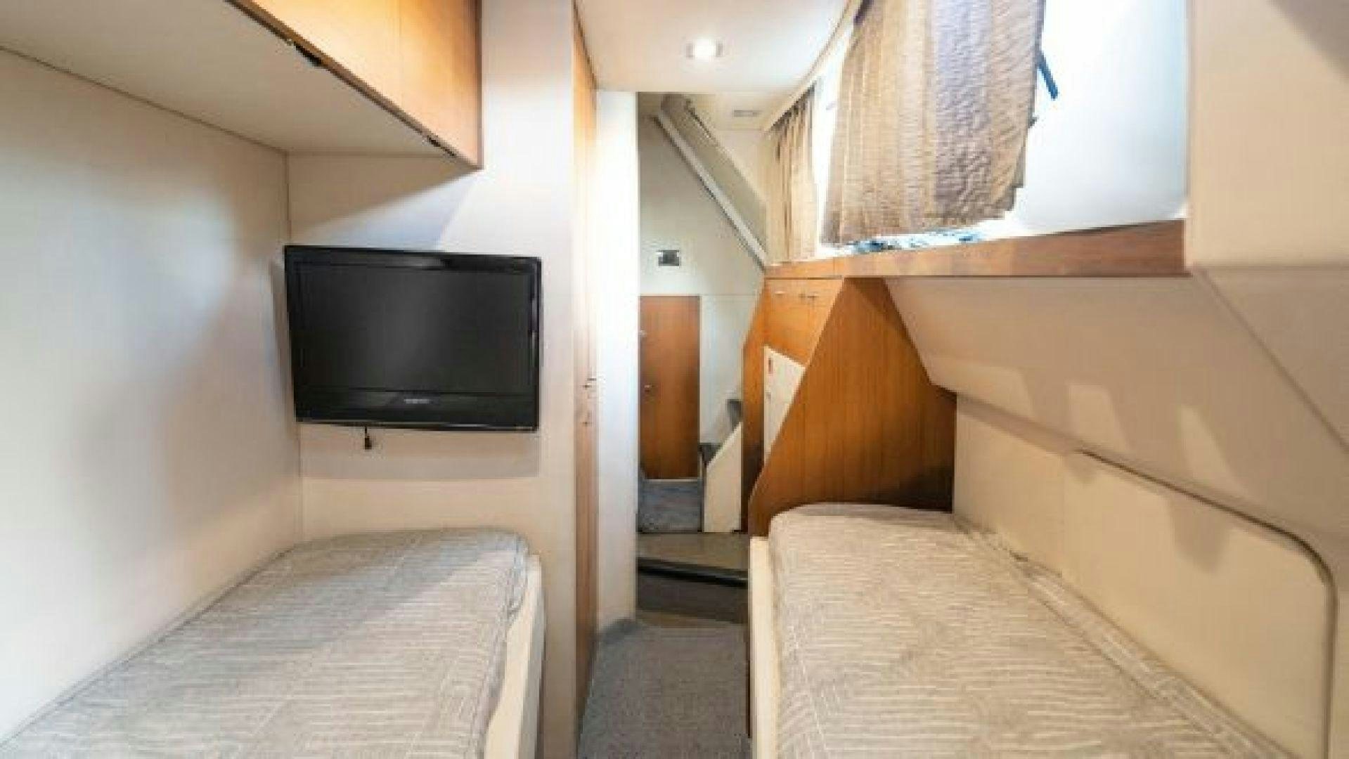 a small bedroom with a tv aboard MANCUSA Yacht for Sale