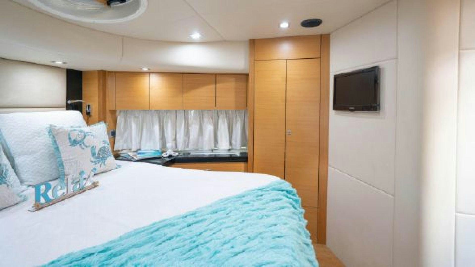 a bedroom with a bed and a television aboard MANCUSA Yacht for Sale