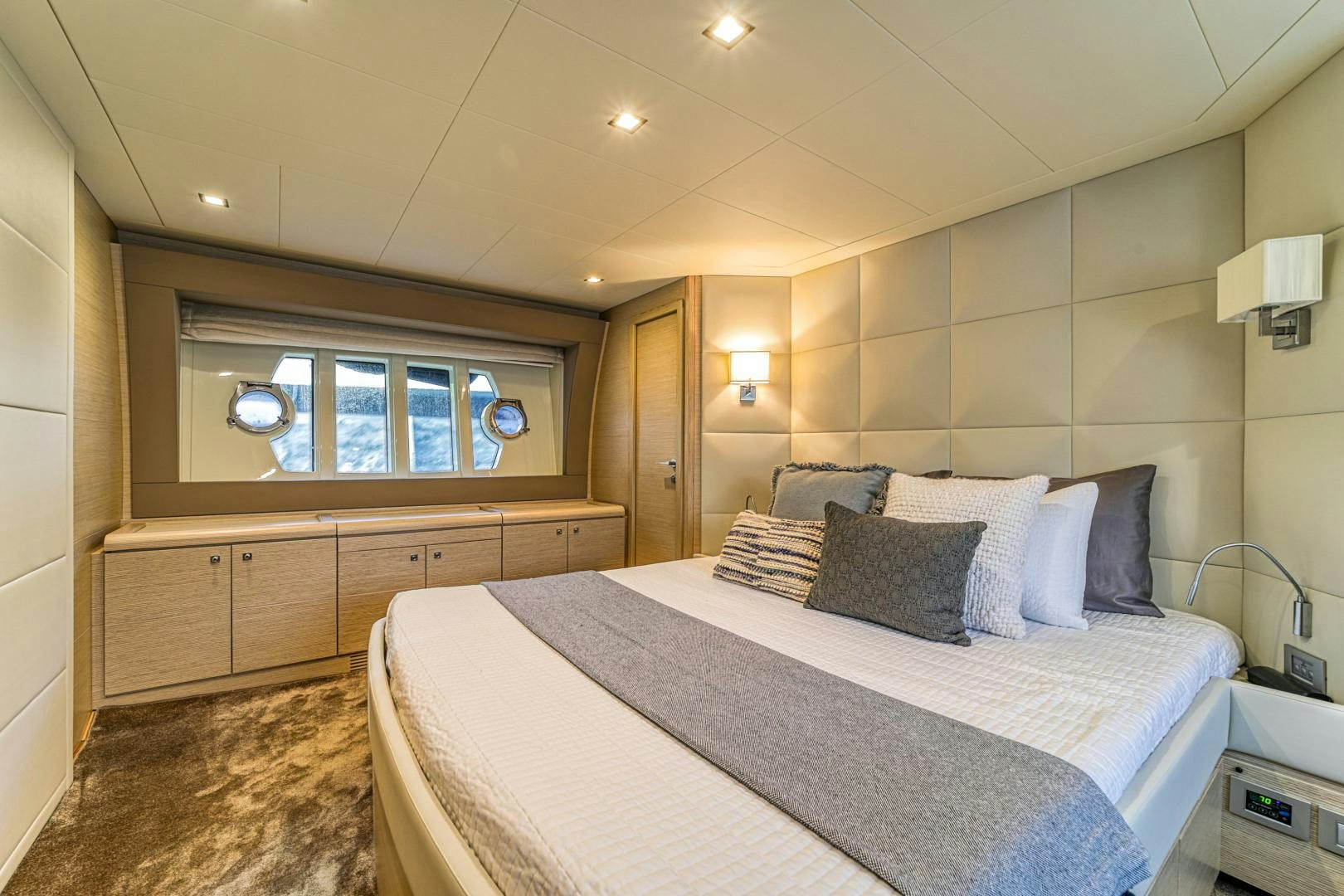 a bedroom with a bed and a mirror aboard KAOS II Yacht for Sale