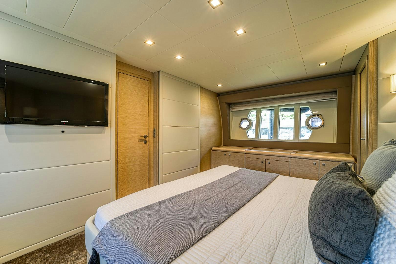 a bedroom with a bed and tv aboard KAOS II Yacht for Sale