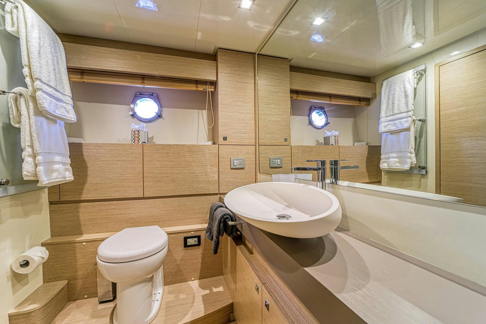 a bathroom with a sink toilet and a bathtub aboard KAOS II Yacht for Sale