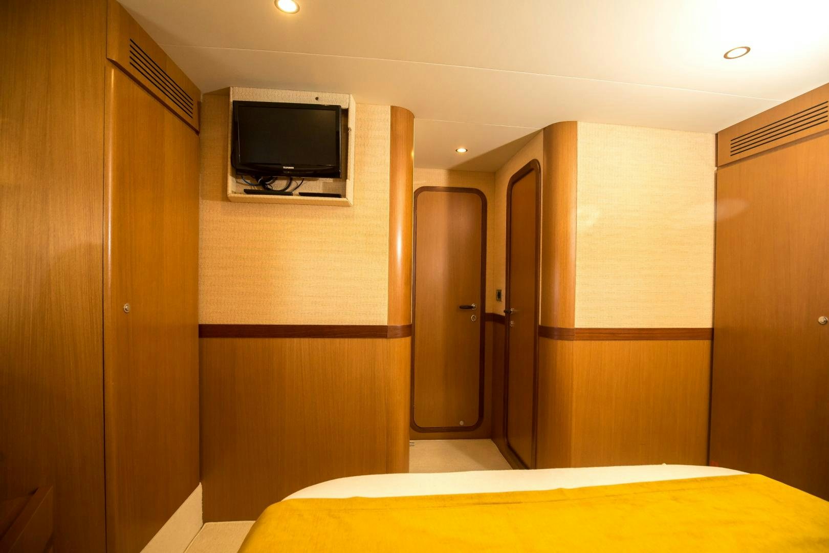 a room with a tv and a bed aboard TESA Yacht for Sale