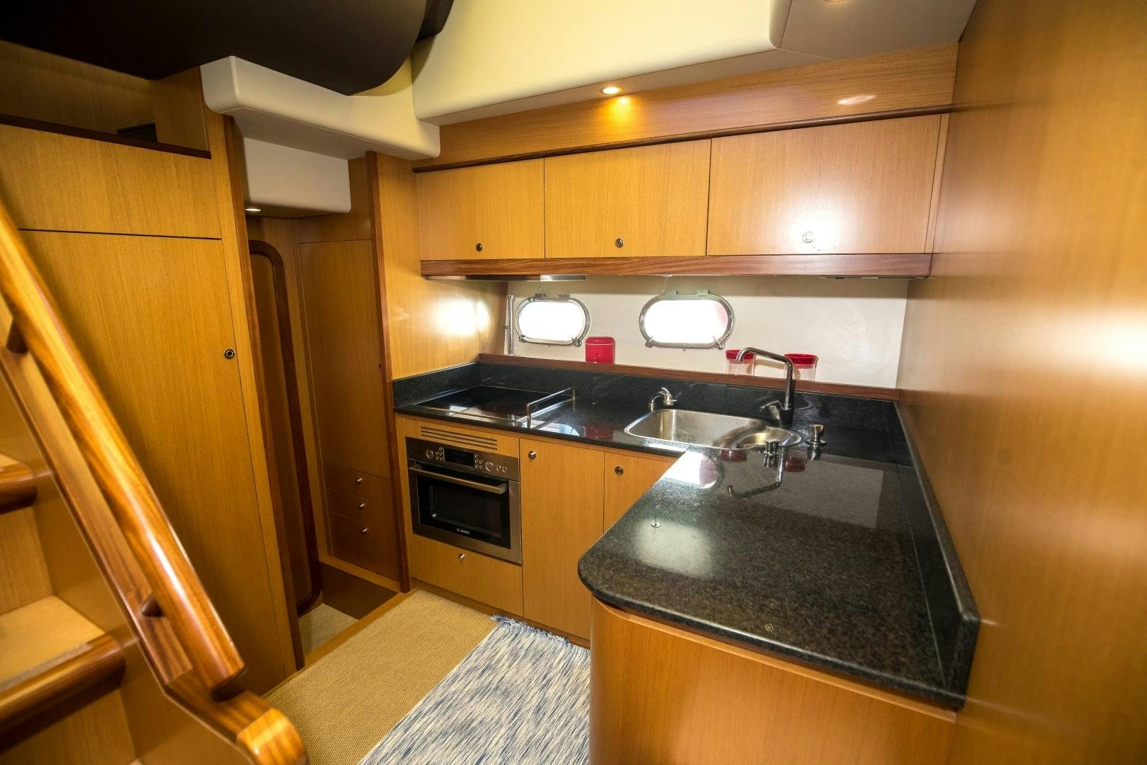 a kitchen with wooden cabinets aboard TESA Yacht for Sale
