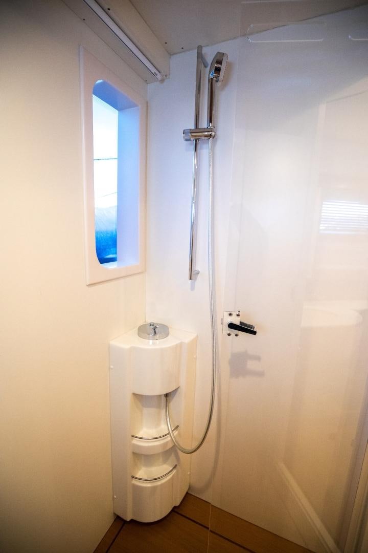 a bathroom with a toilet and a window aboard TESA Yacht for Sale