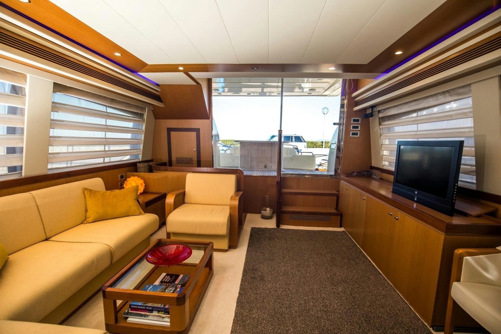 a living room with a tv and couches aboard TESA Yacht for Sale