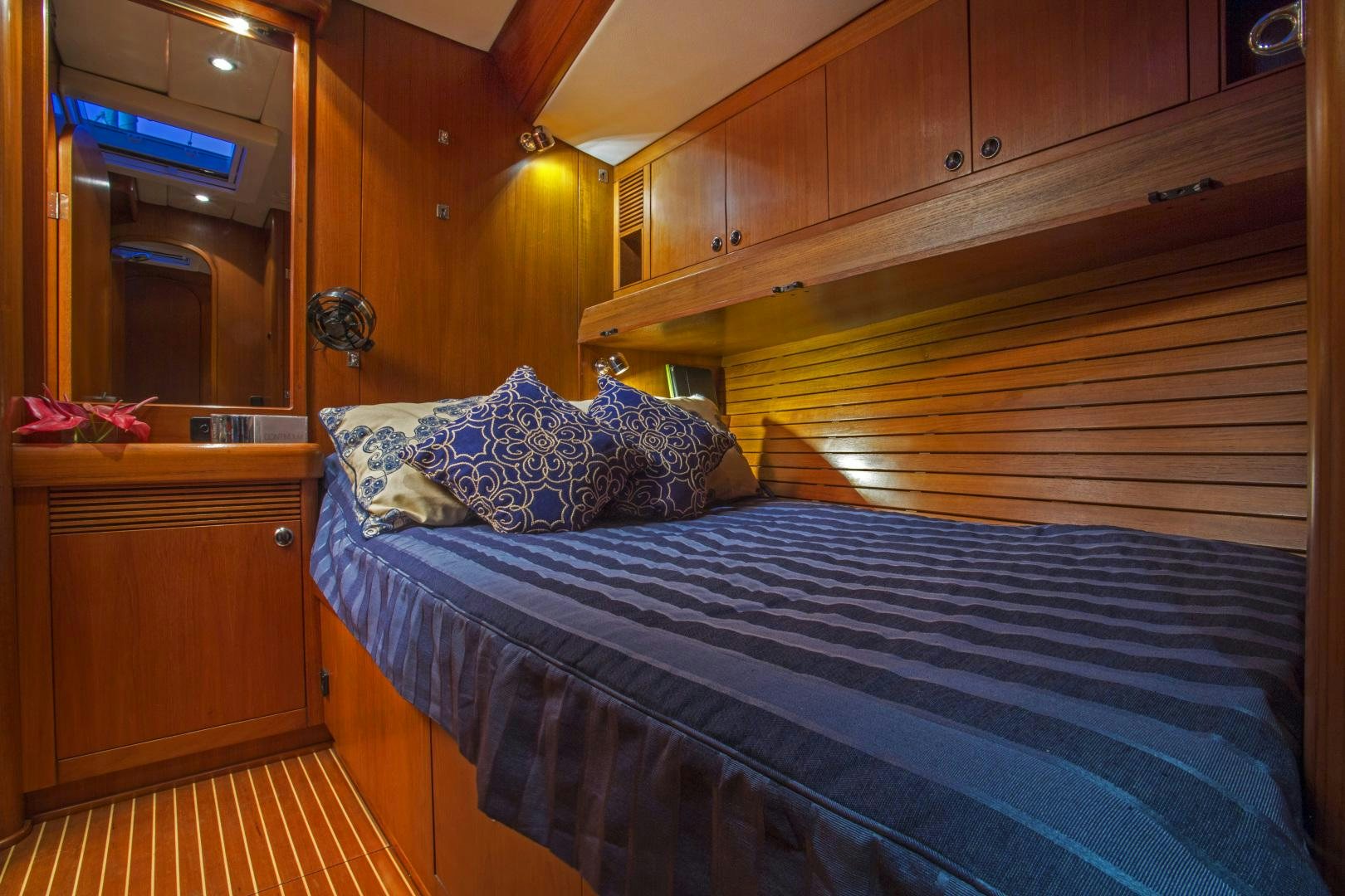 a bed with blue sheets aboard simple harmony Yacht for Sale