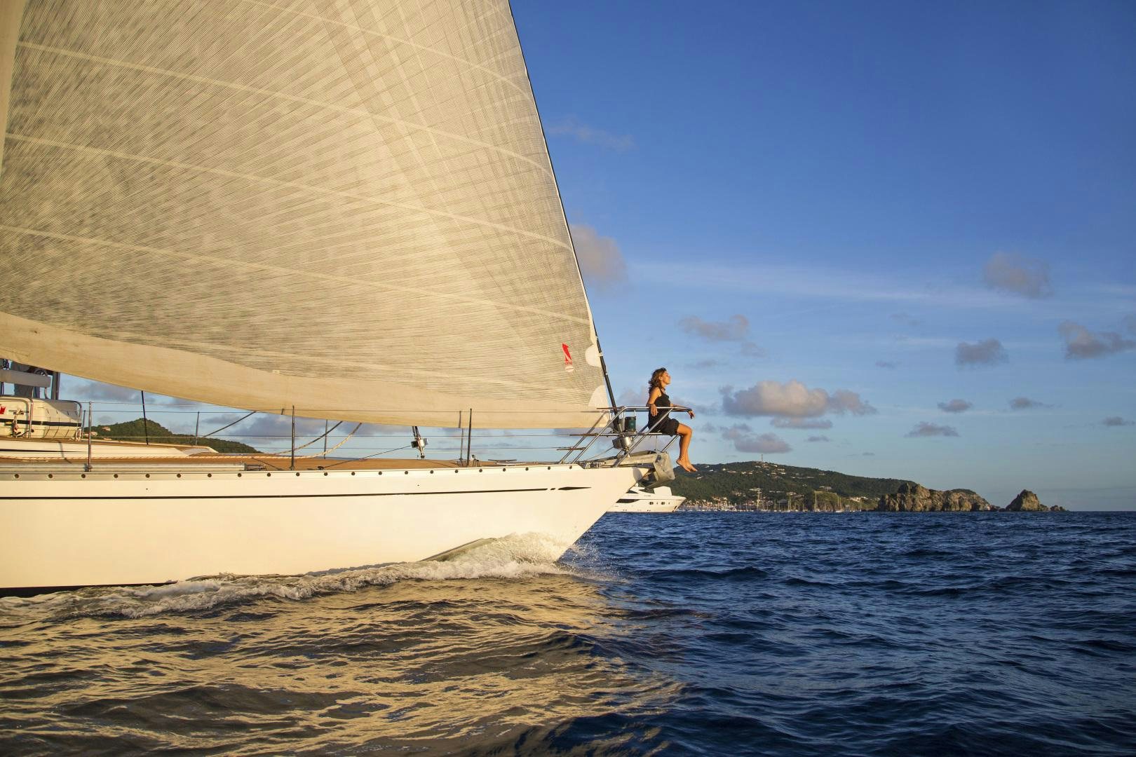 a couple of people on a sailboat in the water aboard simple harmony Yacht for Sale