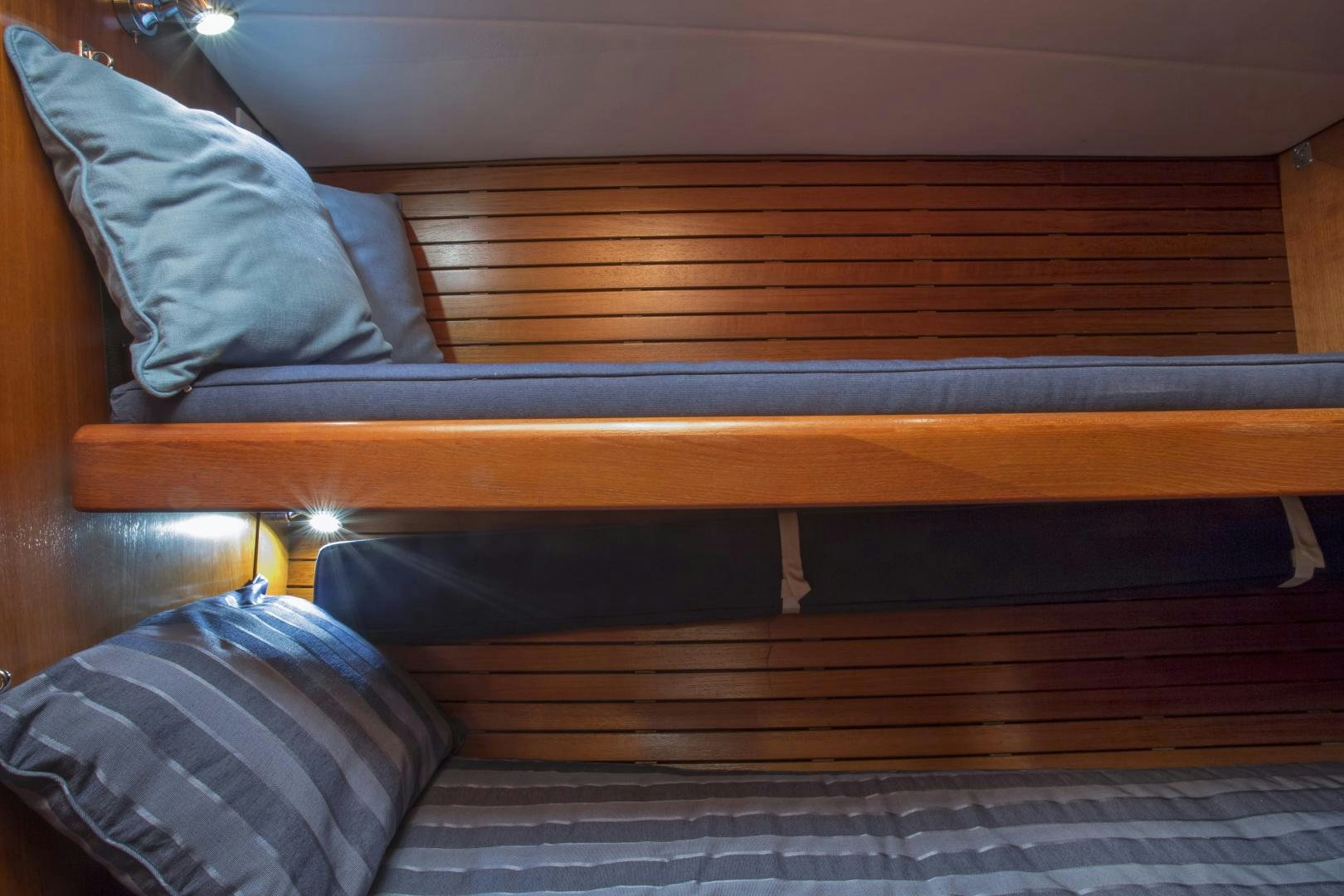 a bed with a blue pillow aboard simple harmony Yacht for Sale