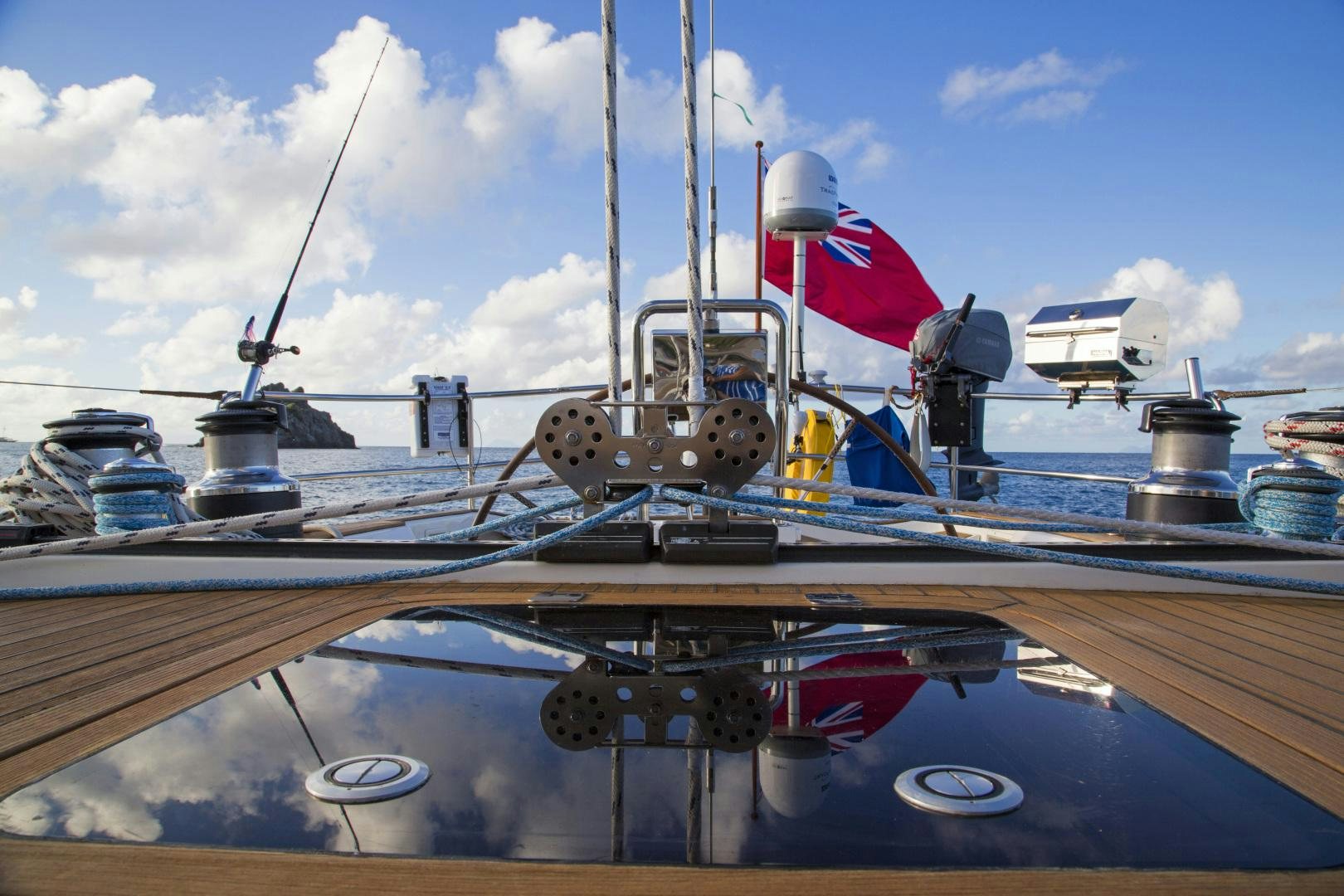 a boat with a flag on the front aboard simple harmony Yacht for Sale