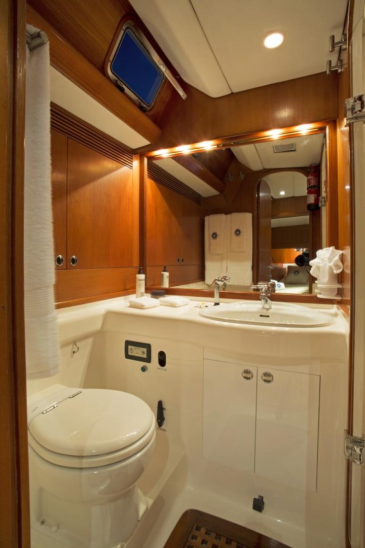 a bathroom with a toilet and a sink aboard simple harmony Yacht for Sale