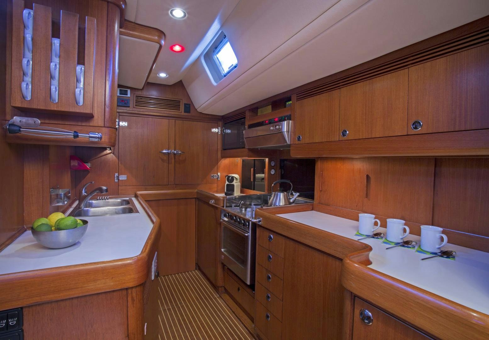 a kitchen with wooden cabinets aboard simple harmony Yacht for Sale