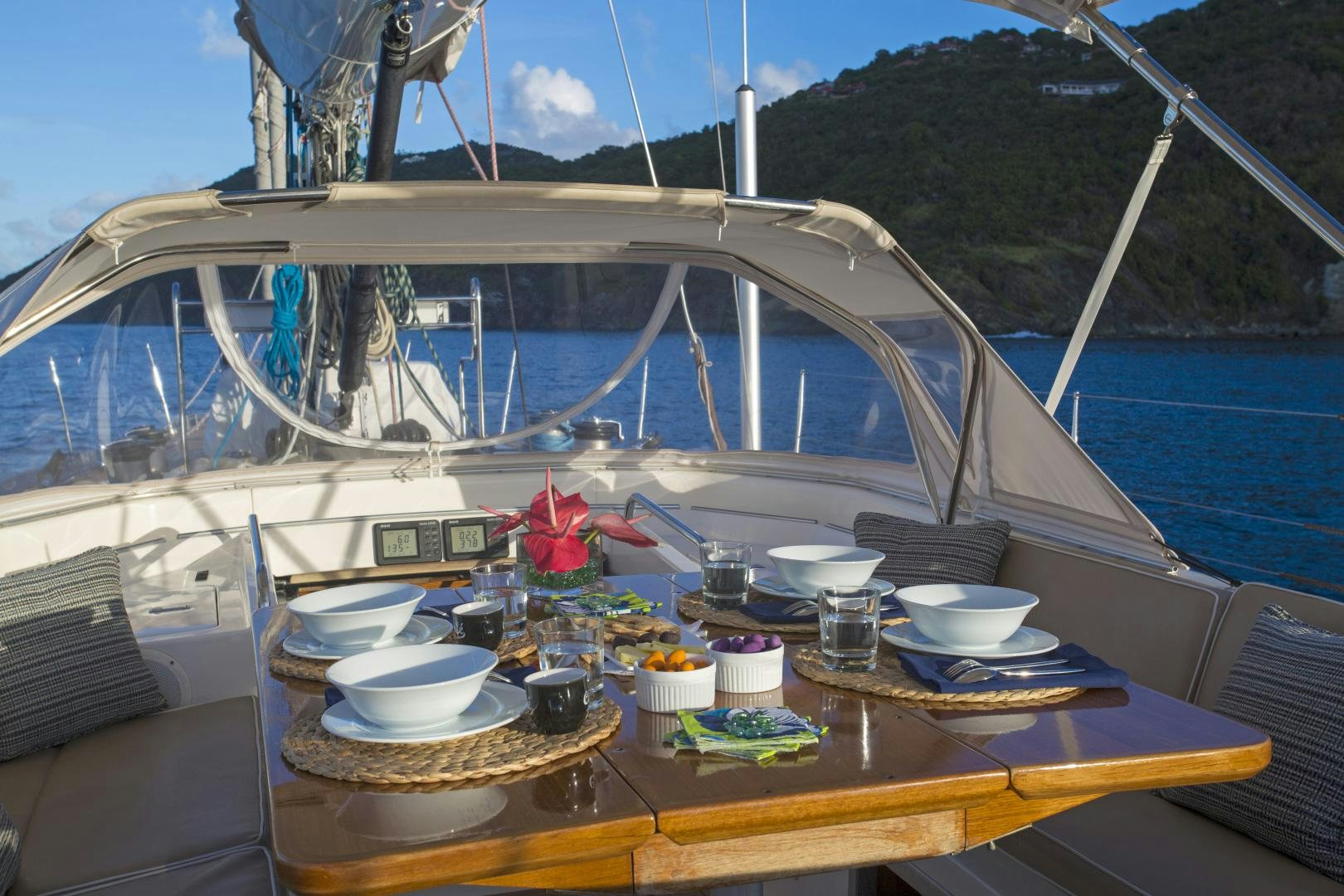 a table with plates and cups on it aboard simple harmony Yacht for Sale