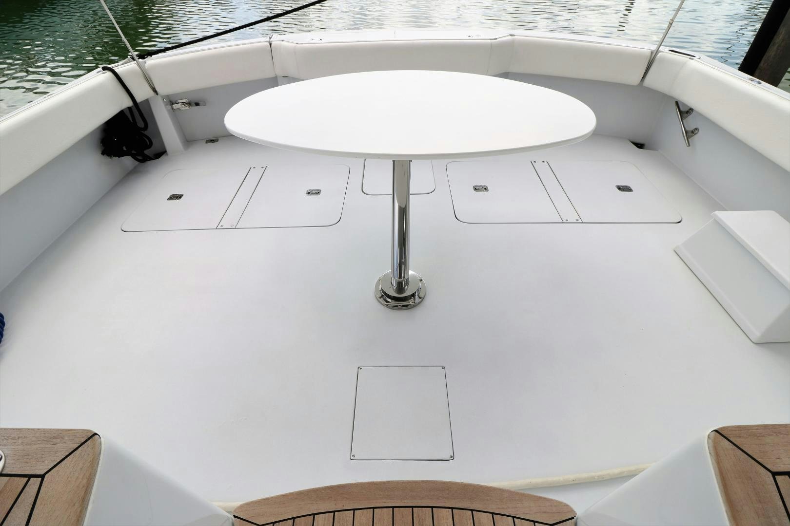 a white table with a white table and chairs on it aboard No Name Yacht for Sale