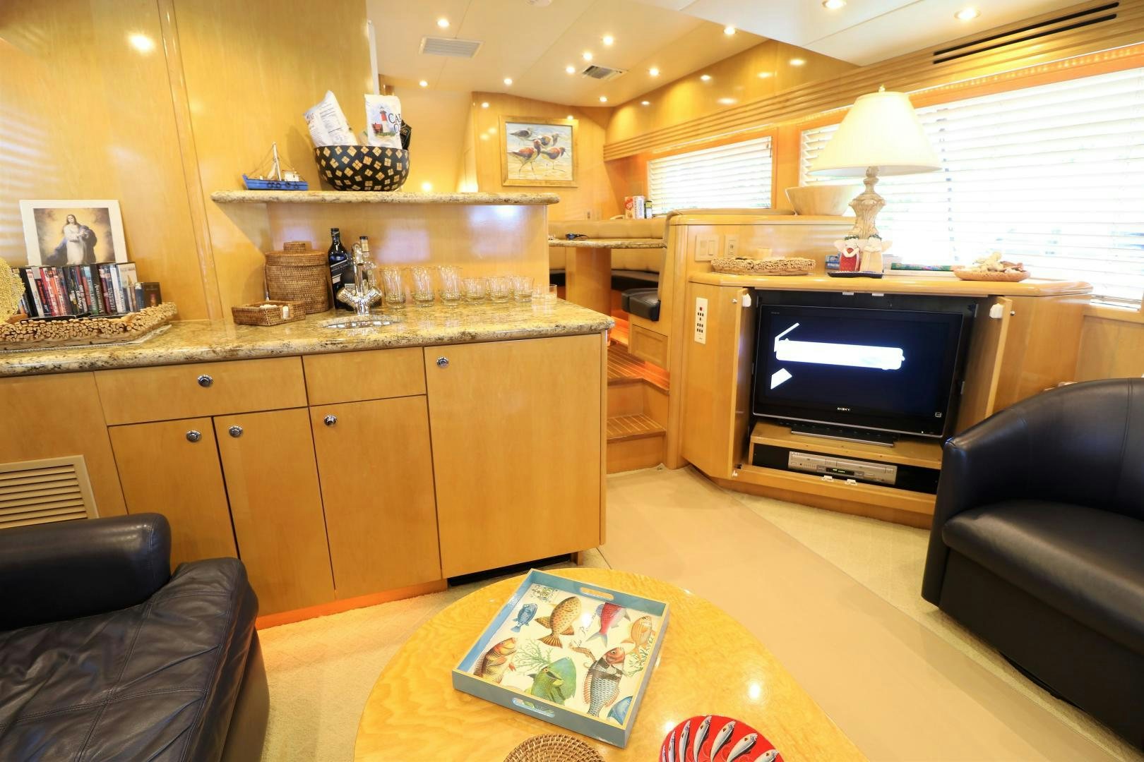 a living room with a tv and a fireplace aboard No Name Yacht for Sale