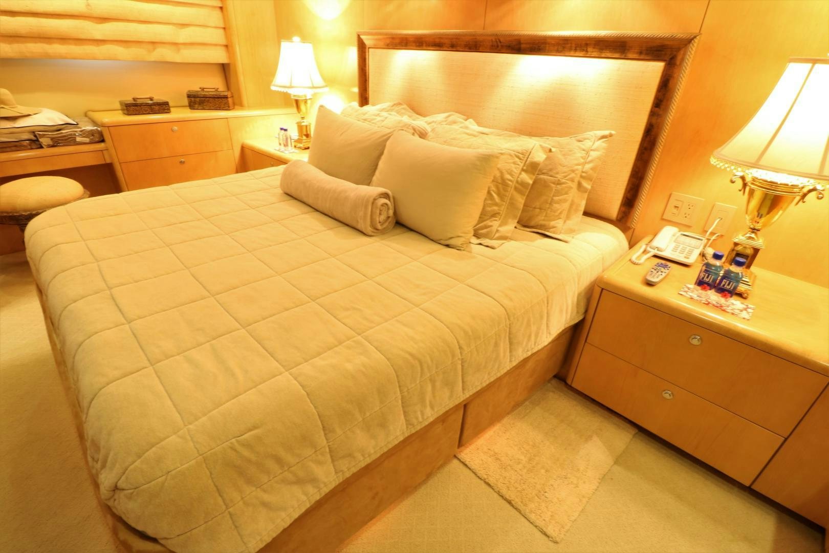 a bed with a white comforter aboard No Name Yacht for Sale