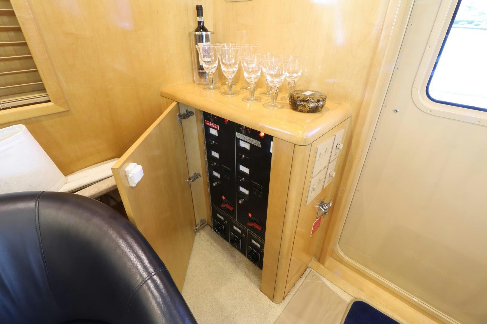 a cabinet with wine glasses on it aboard No Name Yacht for Sale