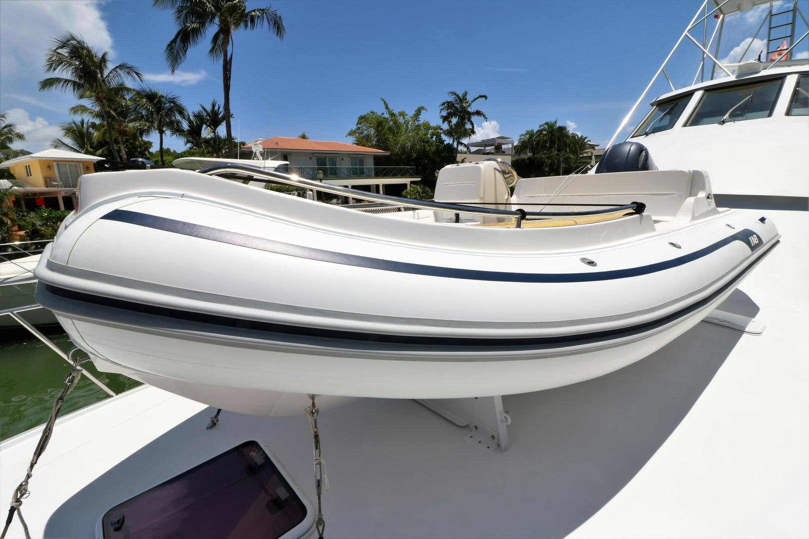 a white boat on a beach aboard No Name Yacht for Sale