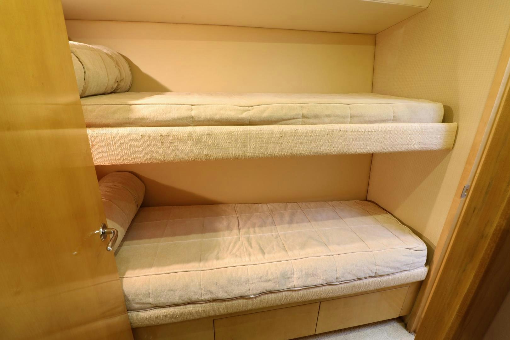a bed with a white sheet aboard No Name Yacht for Sale