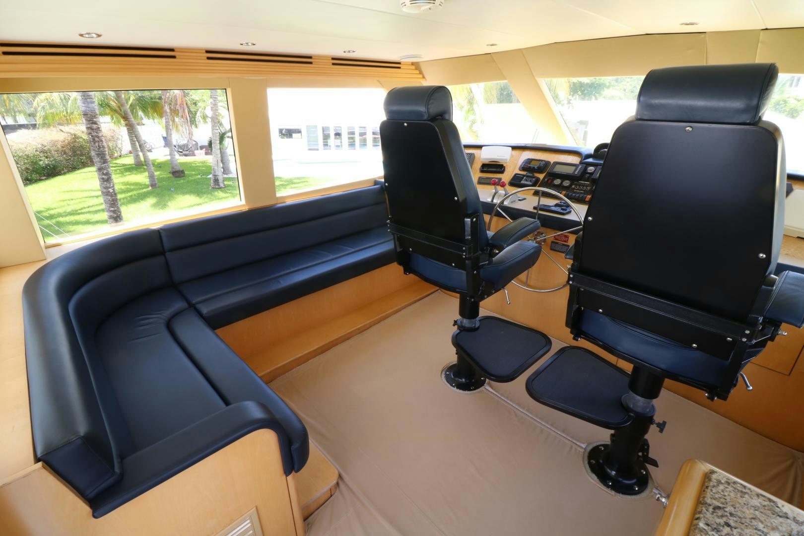a room with a large window and a desk with chairs and a television aboard No Name Yacht for Sale