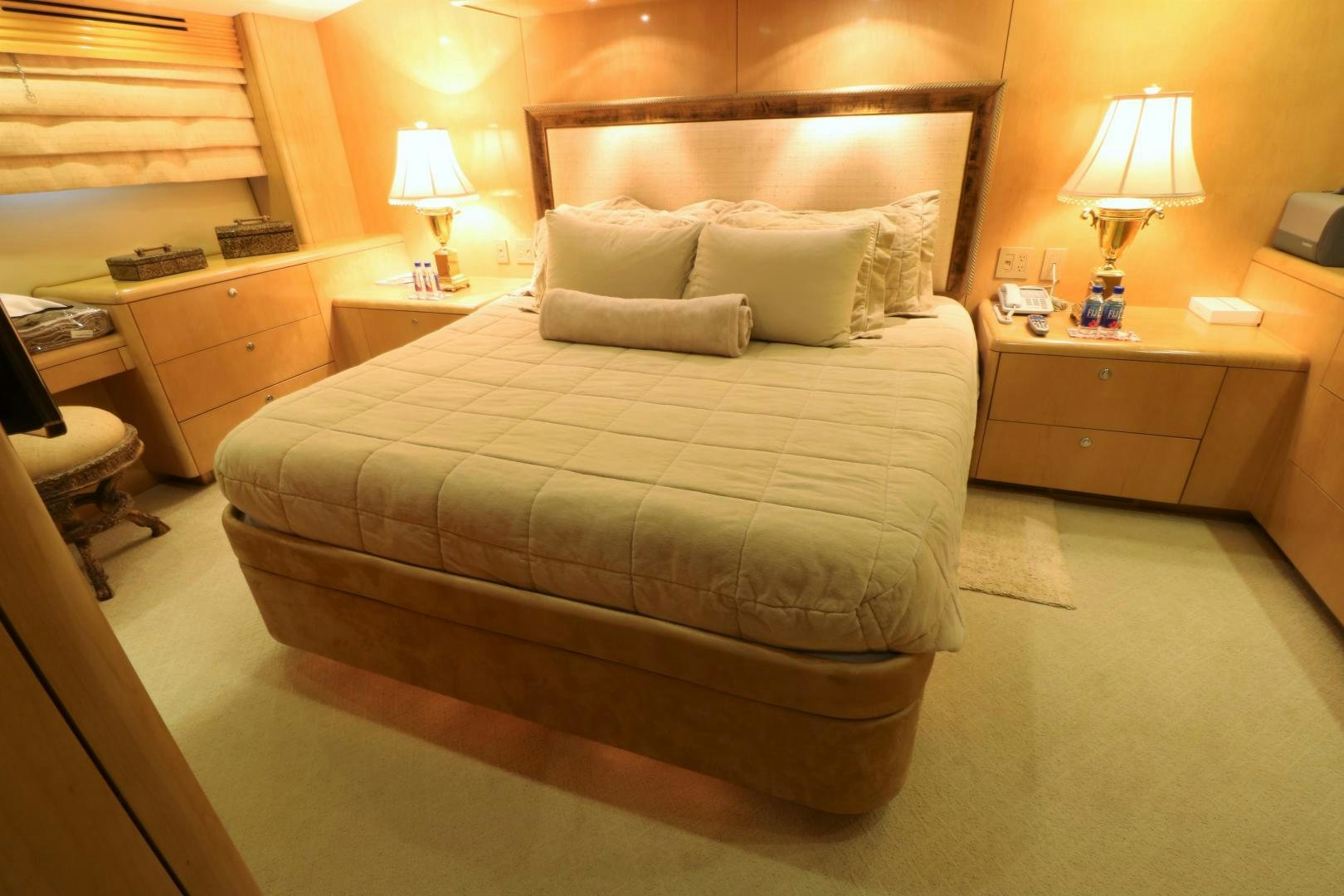 a bed with a couch and a desk in a hotel room aboard No Name Yacht for Sale