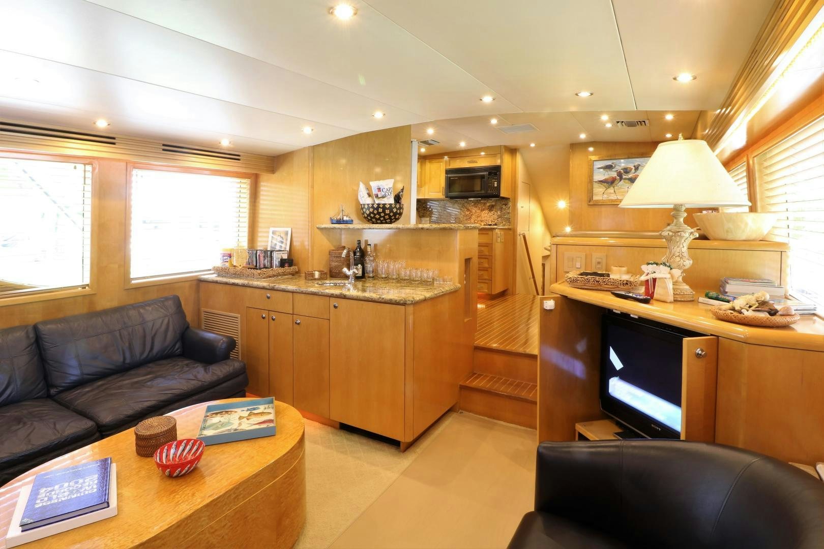 a living room with a couch and a table aboard No Name Yacht for Sale