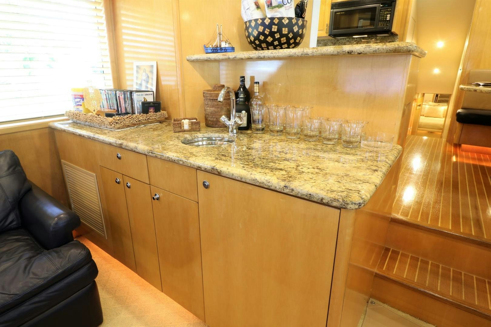 a kitchen with a counter and a chair aboard No Name Yacht for Sale