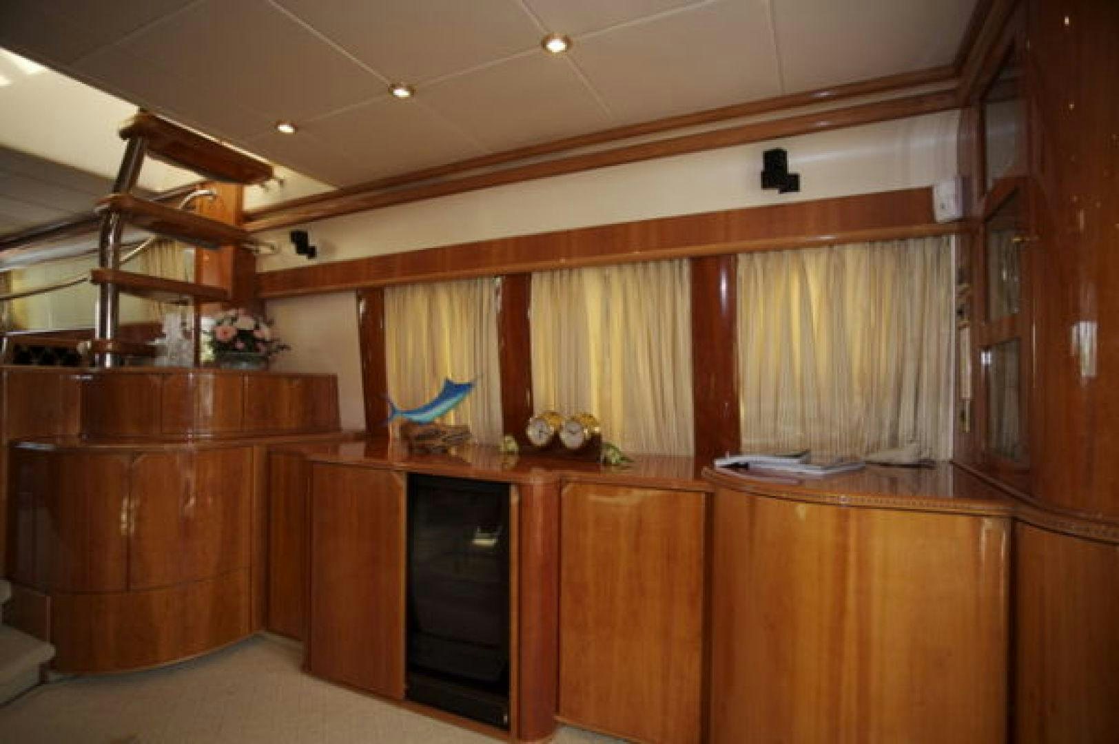 a room with wooden cabinets and a blue object on the wall aboard LADY KARIMAN Yacht for Sale