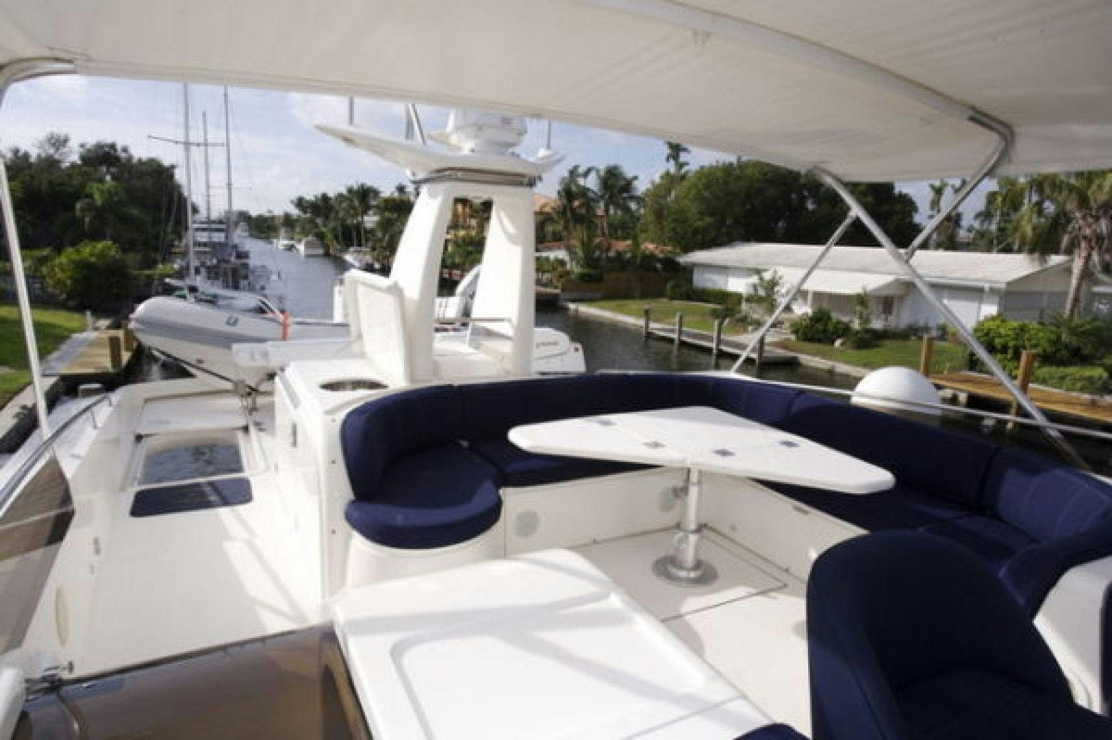 a white boat with a white table and chairs on it aboard LADY KARIMAN Yacht for Sale