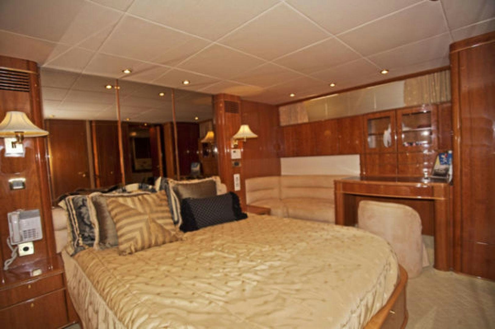a bedroom with a bed and a desk aboard LADY KARIMAN Yacht for Sale
