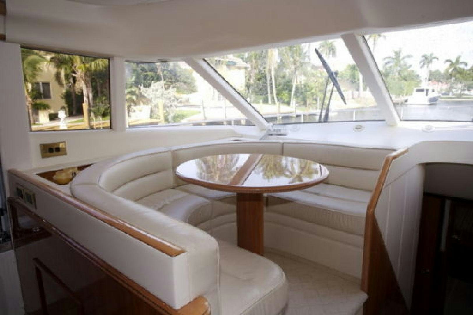 a room with a table and chairs aboard LADY KARIMAN Yacht for Sale