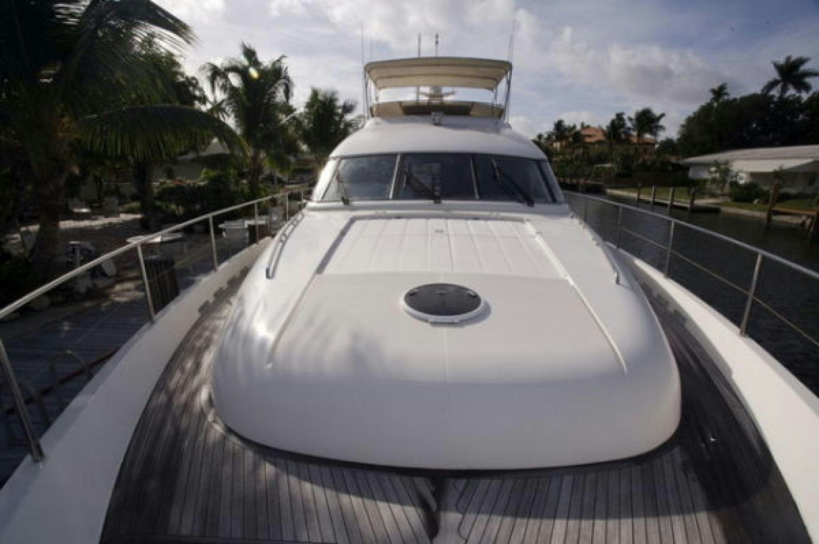 a white and silver boat on a wooden dock aboard LADY KARIMAN Yacht for Sale