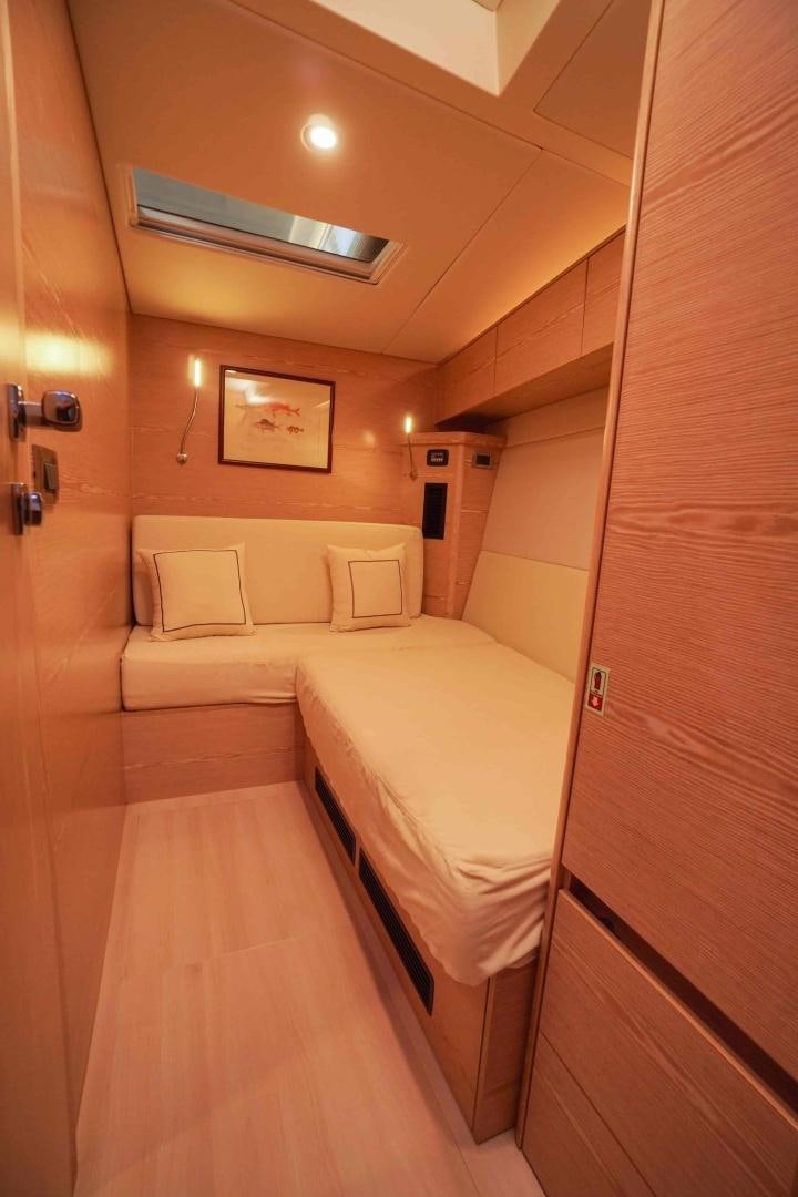 a room with a bed and a mirror aboard horizon Yacht for Sale