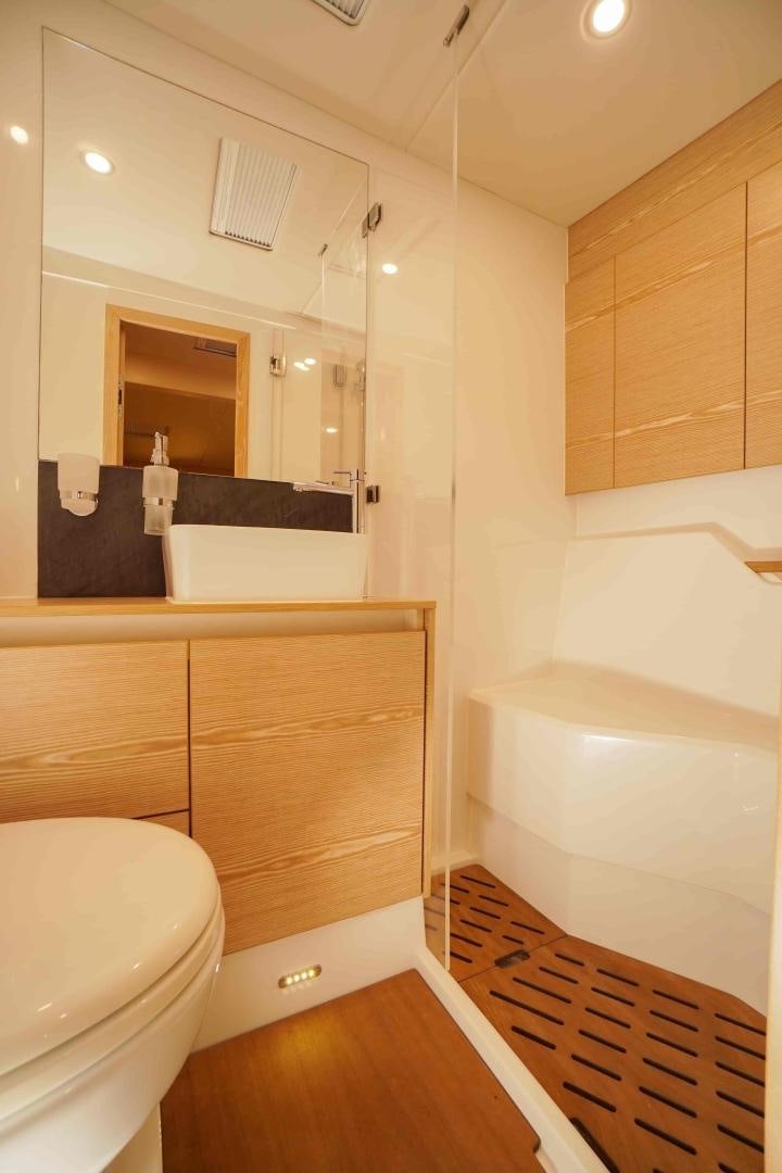 a bathroom with a tub sink and toilet aboard horizon Yacht for Sale