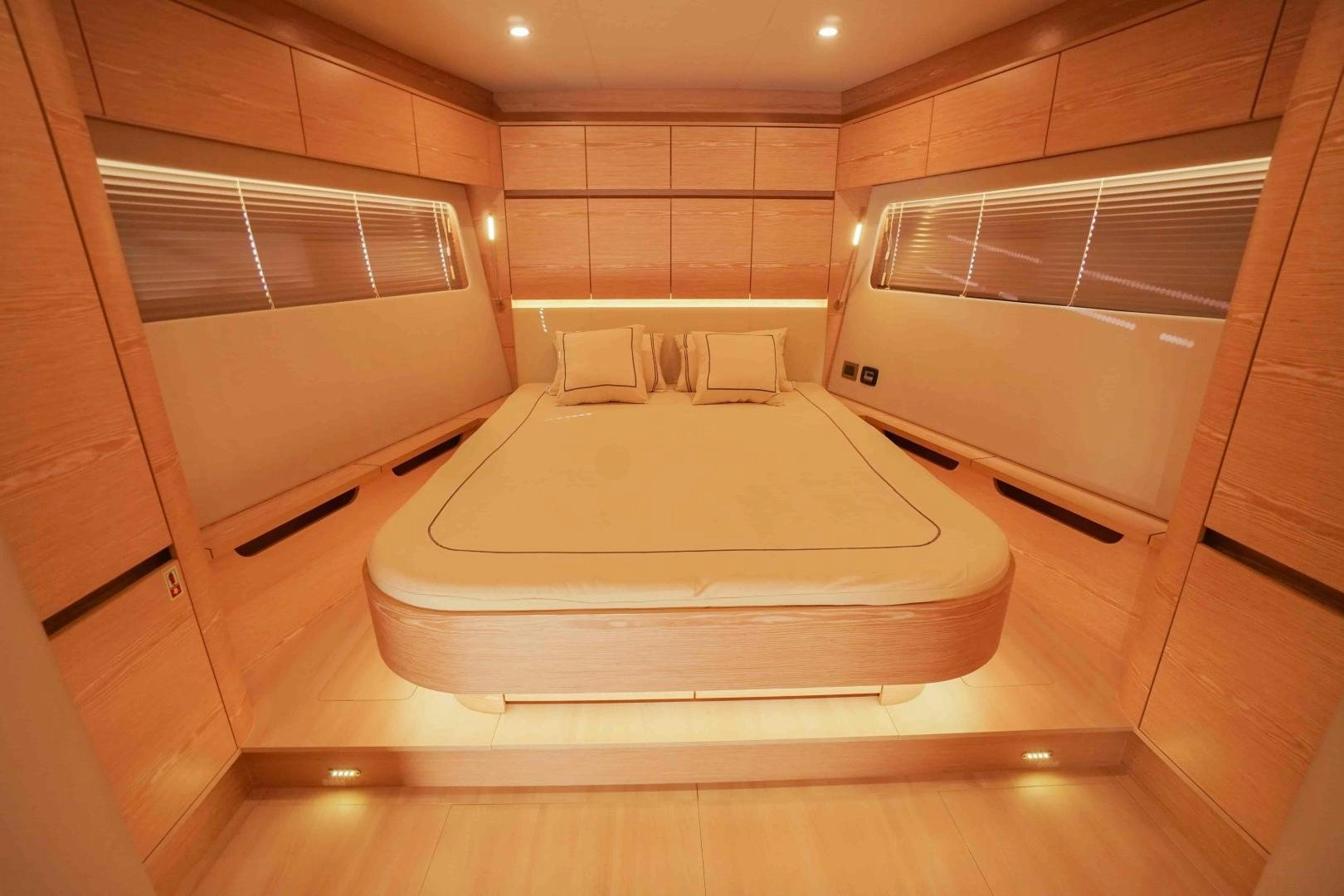 a large white bathtub in a room with tile walls aboard horizon Yacht for Sale