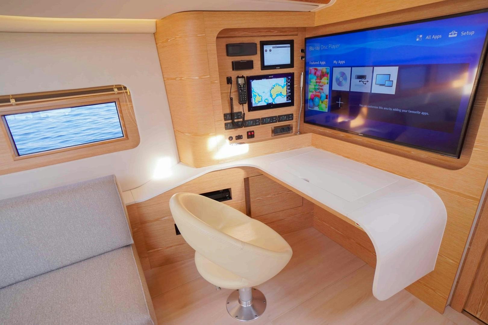 a room with a couch and a tv on the wall aboard horizon Yacht for Sale