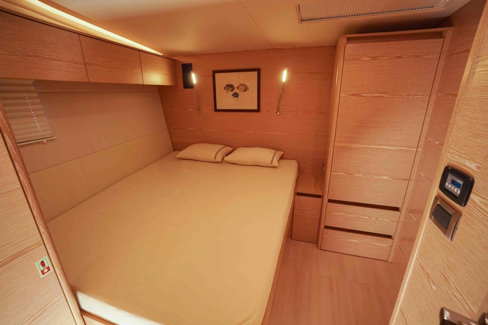 a room with a bed and a wood door aboard horizon Yacht for Sale