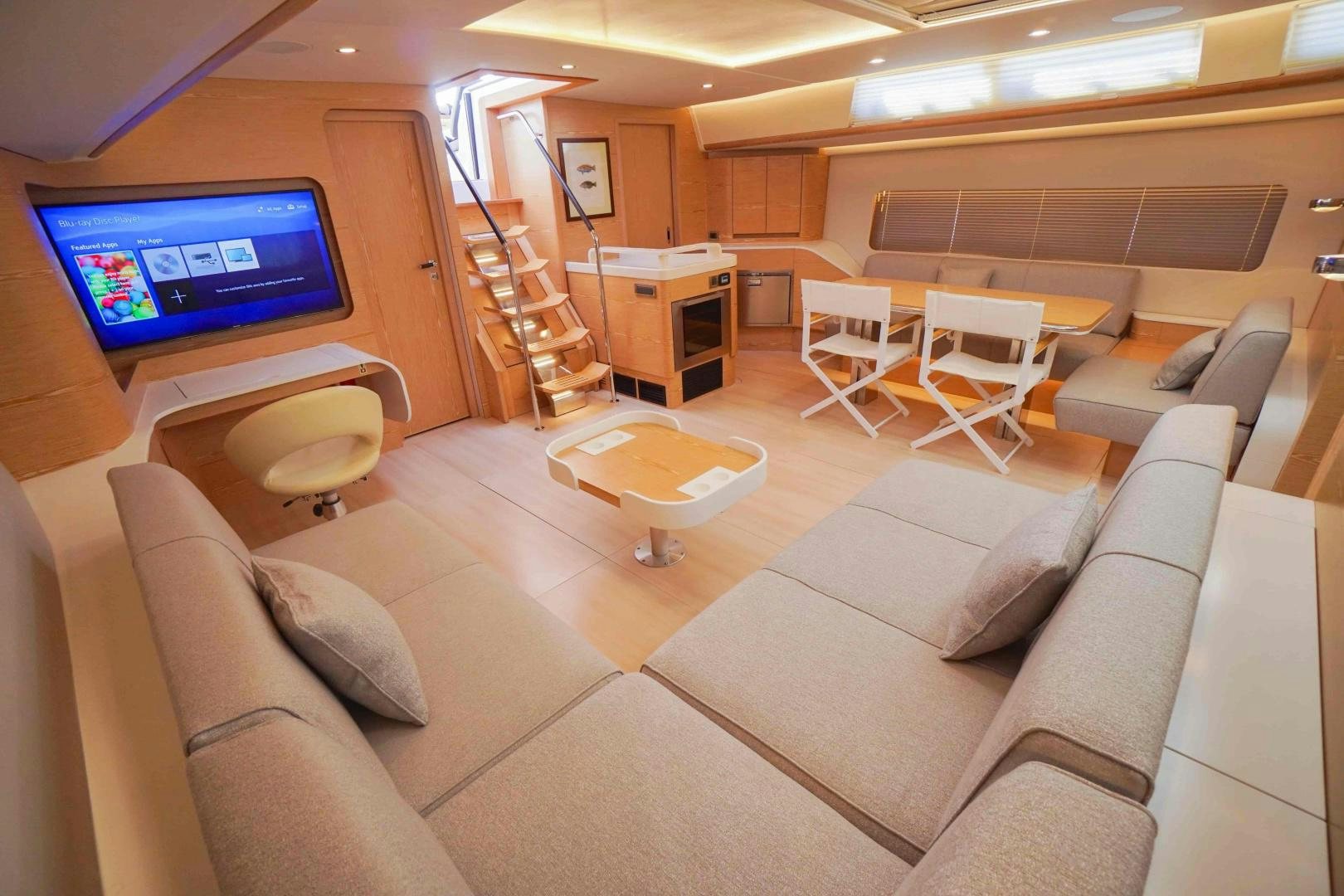 a room with a couch and a tv aboard horizon Yacht for Sale
