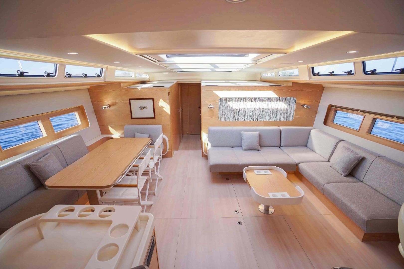a room with couches and a table aboard horizon Yacht for Sale
