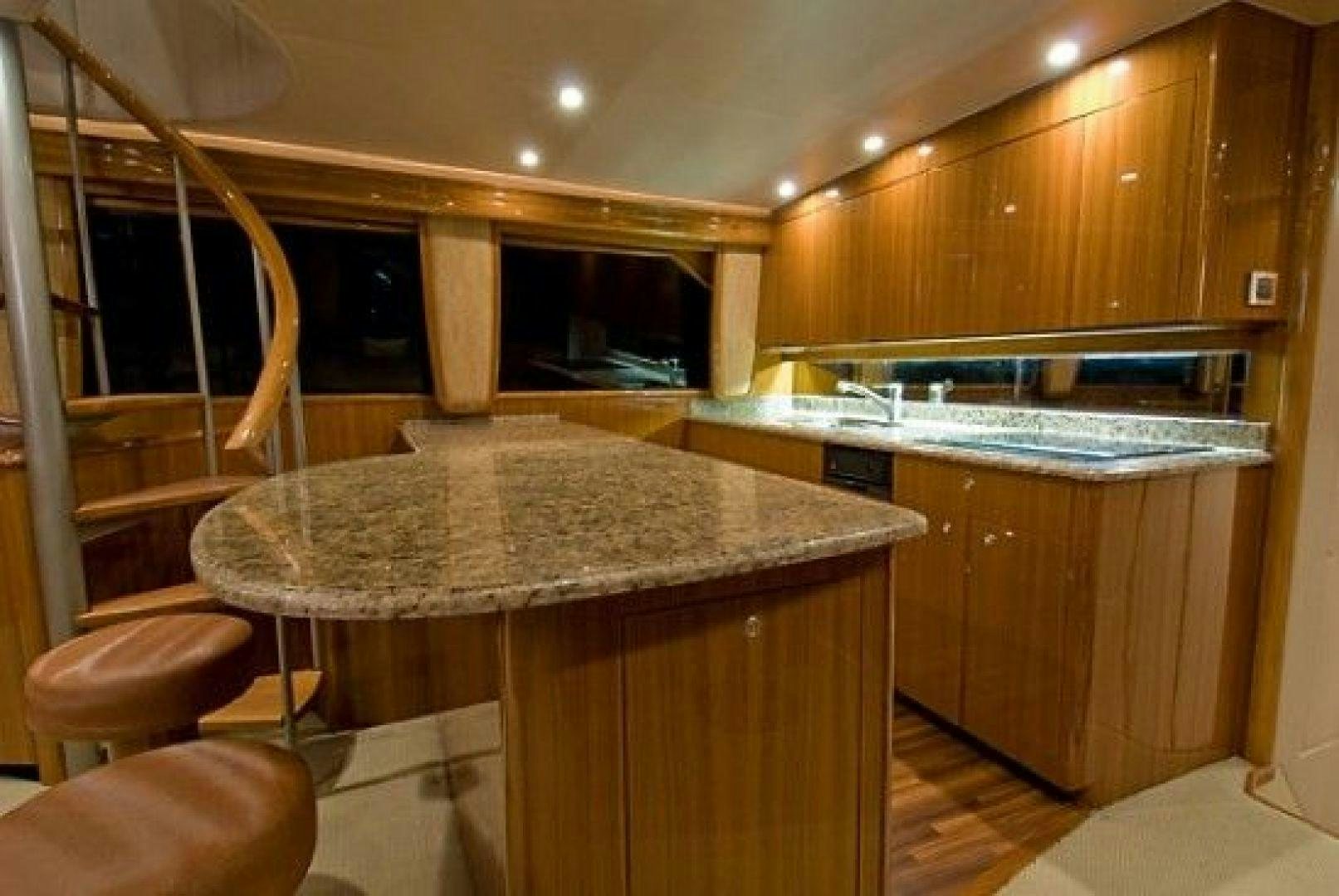 a kitchen with a bar and stools aboard NO NAME 68 Yacht for Sale