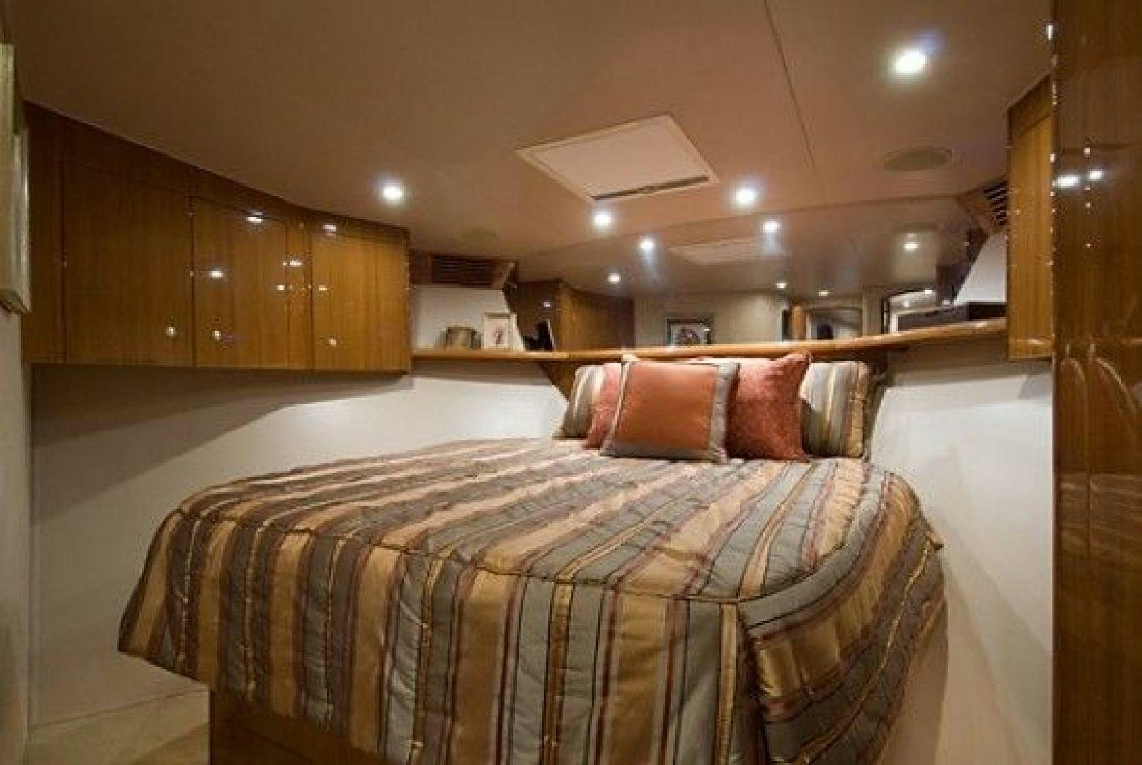 a bed with a brown and white comforter and a white ceiling aboard NO NAME 68 Yacht for Sale