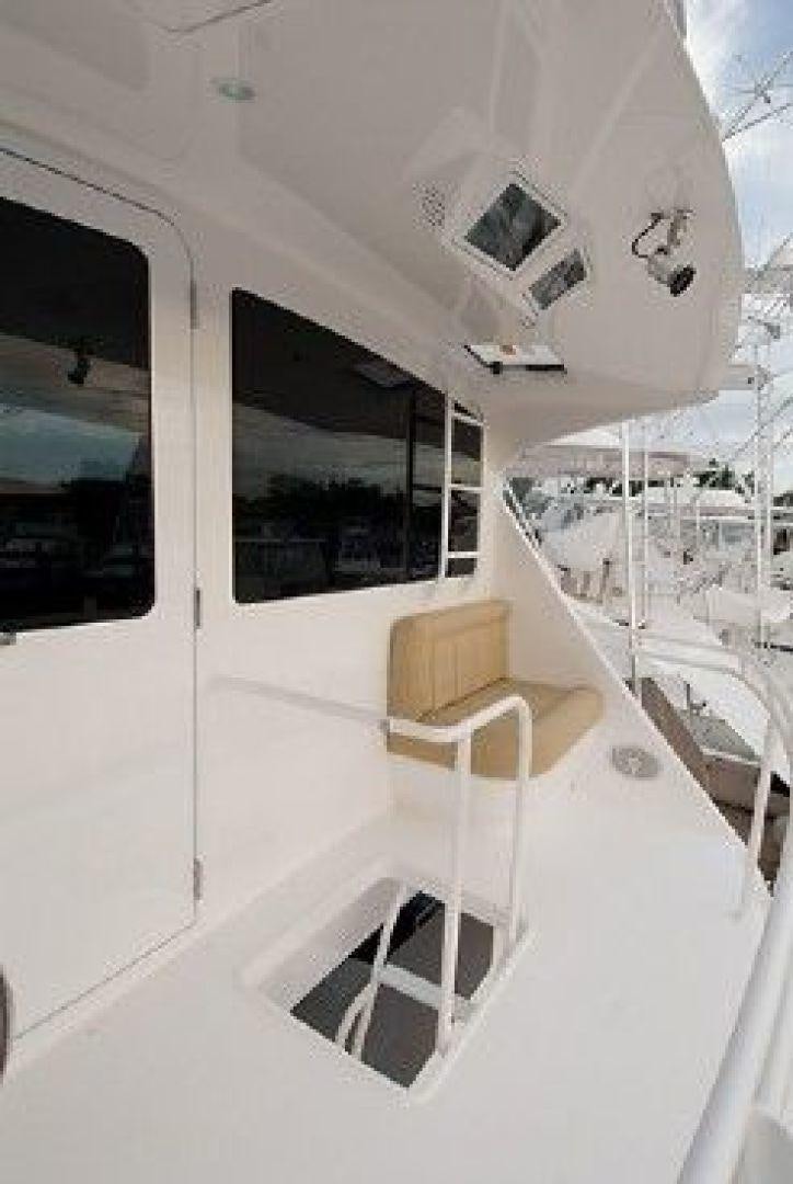 a white building with a black and white roof and a white chair aboard NO NAME 68 Yacht for Sale