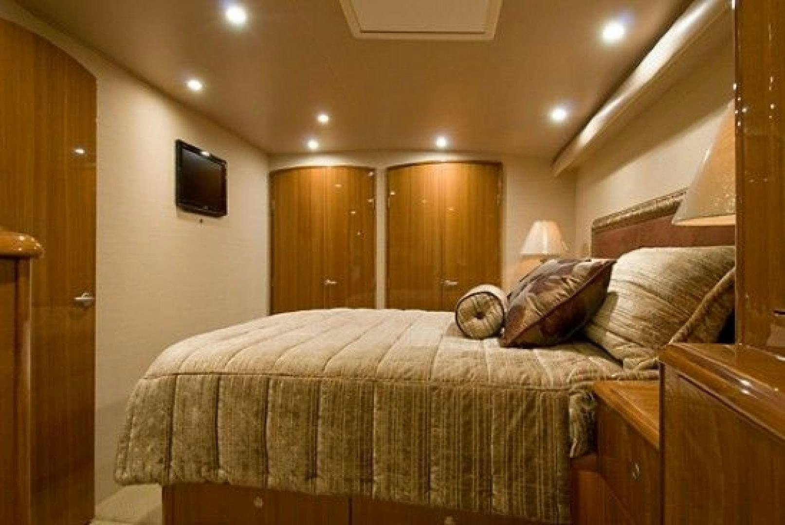 a bed with a television on the wall aboard NO NAME 68 Yacht for Sale