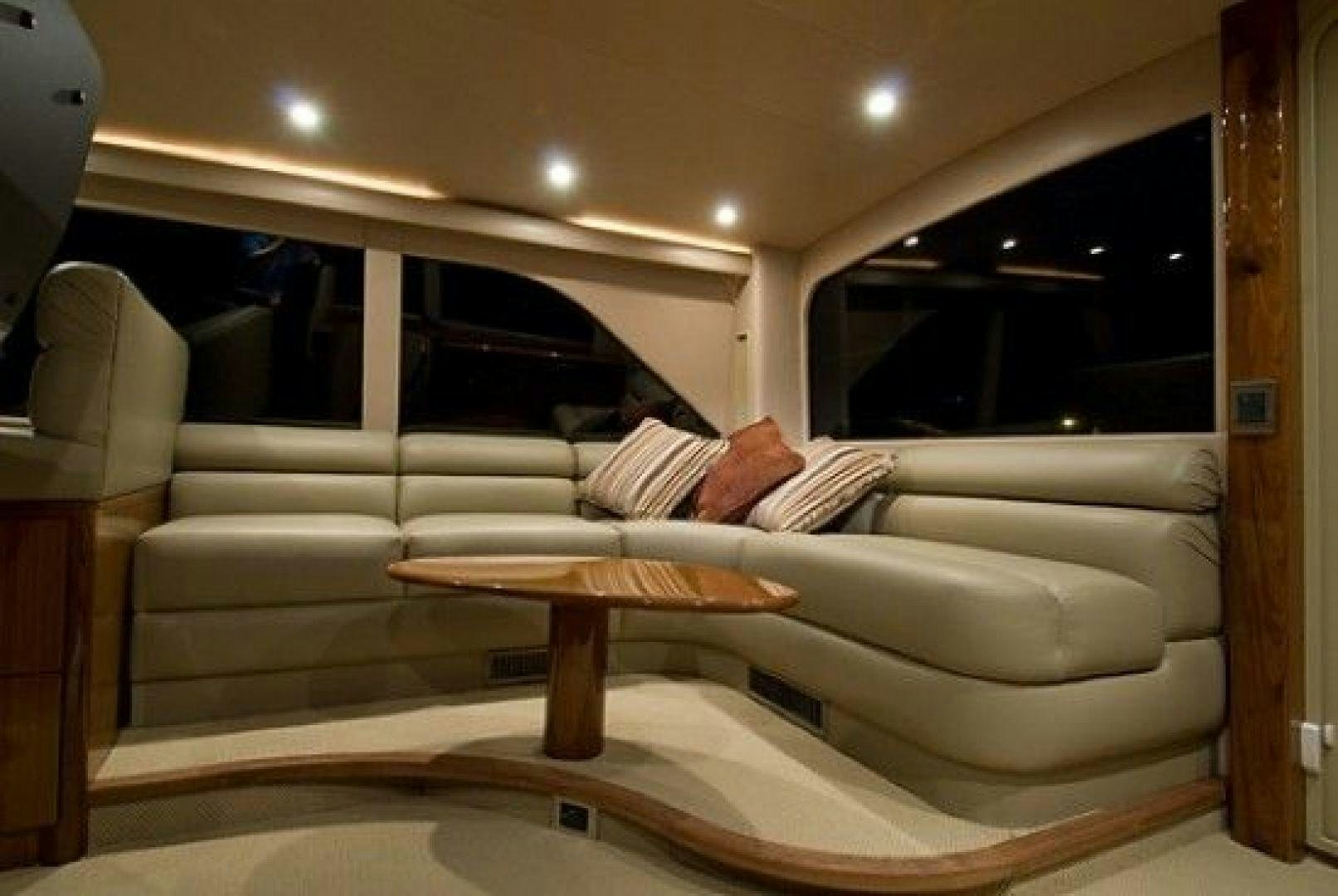 a couch with a table in a room with a window aboard NO NAME 68 Yacht for Sale