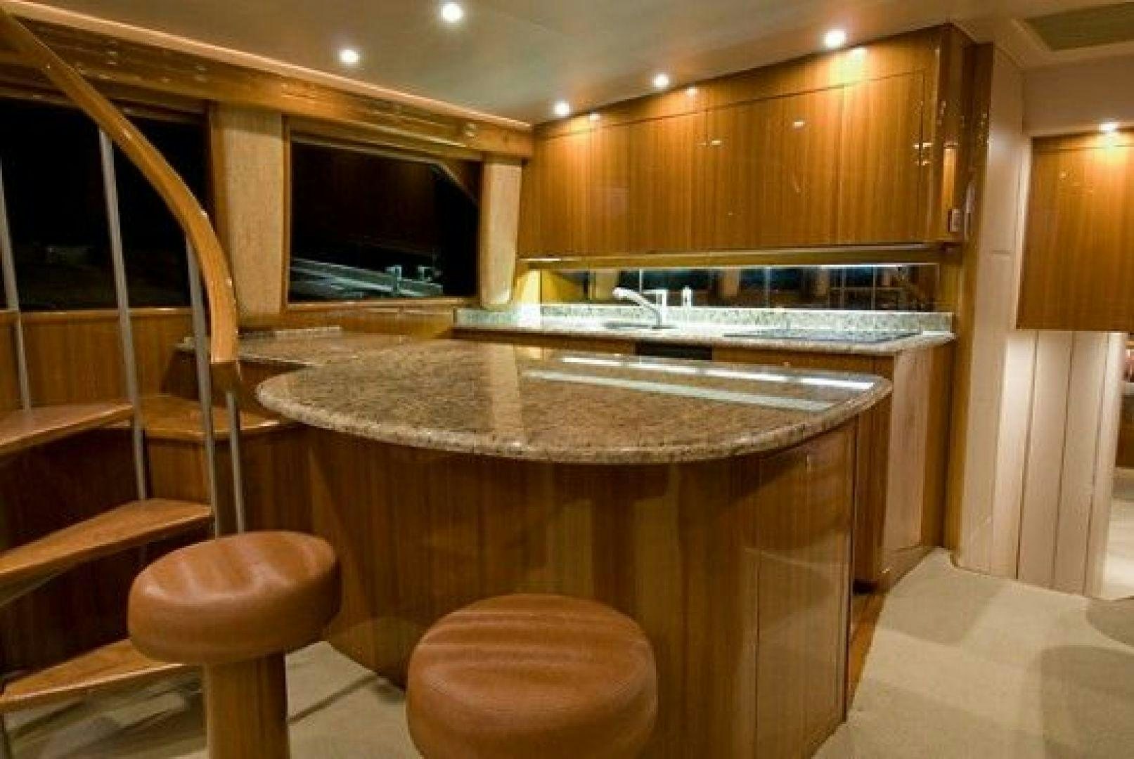 a kitchen with a bar and stools aboard NO NAME 68 Yacht for Sale