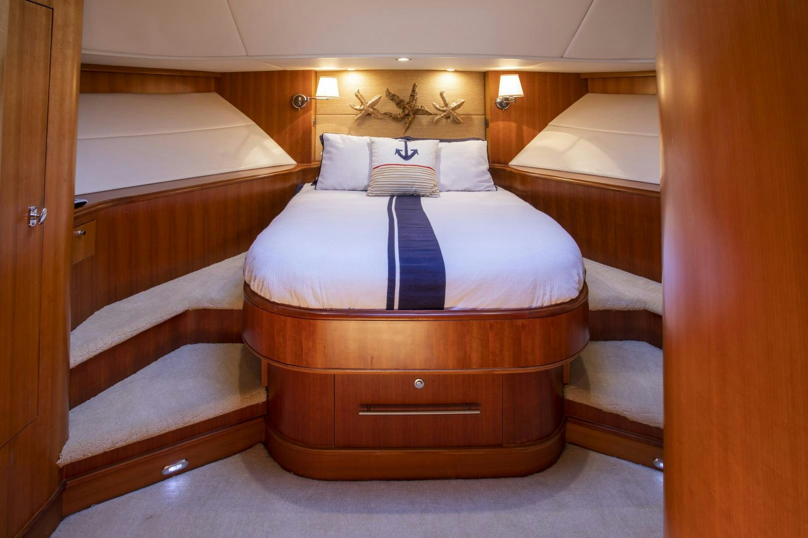 a bed with a purple and white striped pillow aboard DIAMANTE  Yacht for Sale