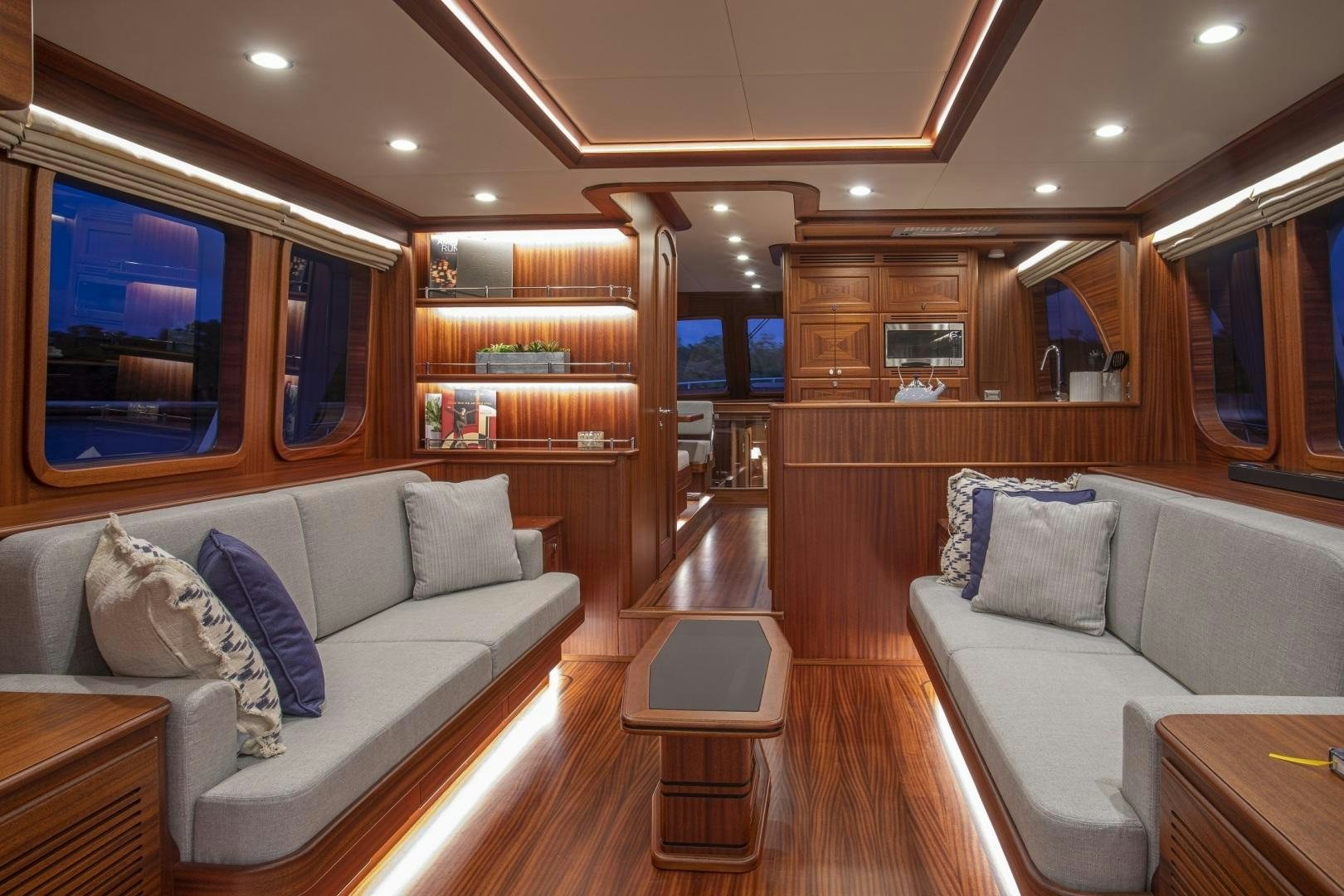 a living room with a couch and a coffee table aboard 67 CRUISER Yacht for Sale