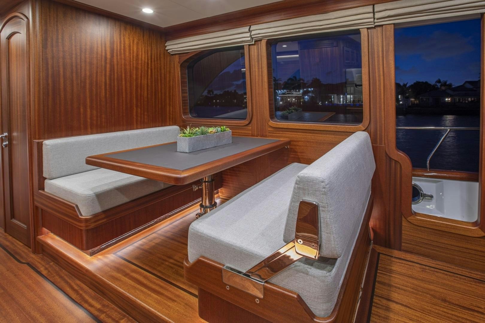 a room with a table and chairs aboard 67 CRUISER Yacht for Sale